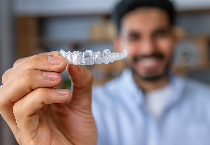 Central Dental Family - Patient holding their Invisalign