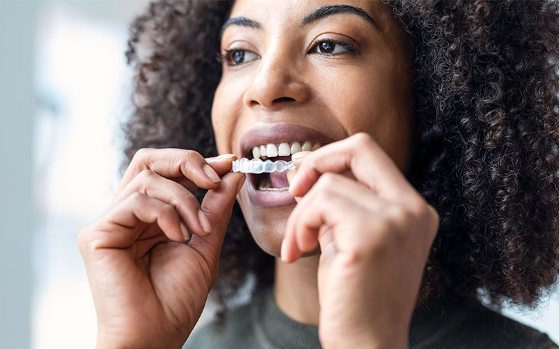 Central Dental Family - Patient holding their Invisalign