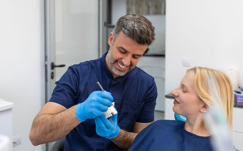 Central Dental Family - Dentist talking to a patient